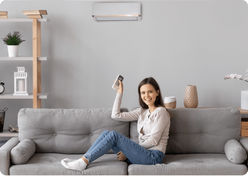 Woman relaxing on sofa with remote control.